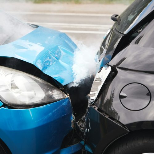 Close Up Of Two Cars Damaged In Road Traffic Accident